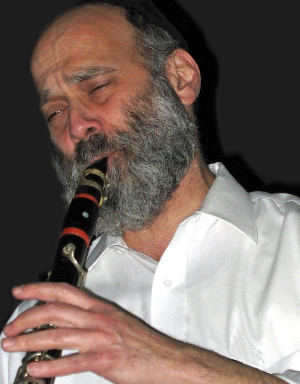 A man plays a saxophone.