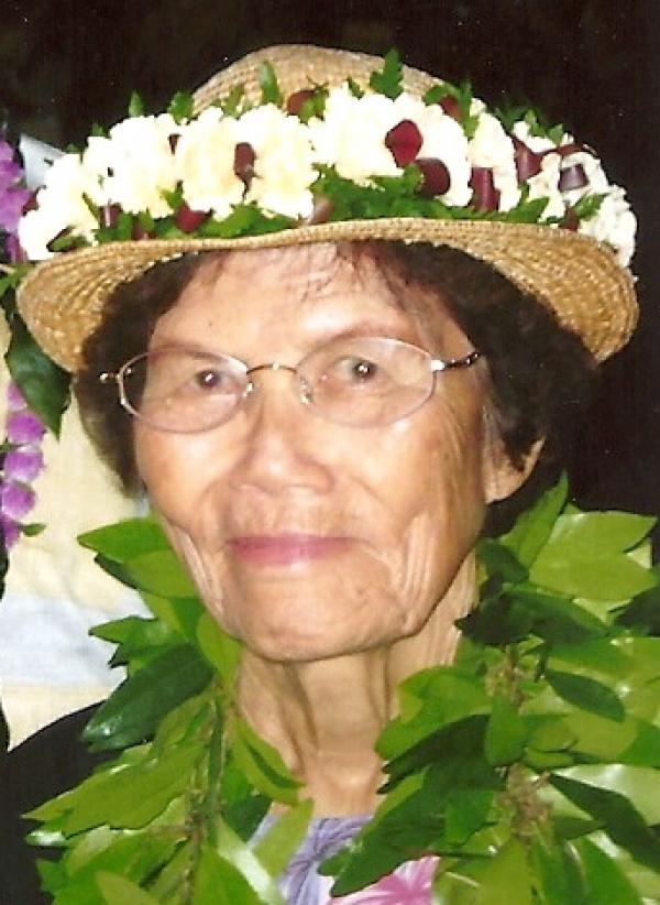 Portrait of woman with flower-laced hat.