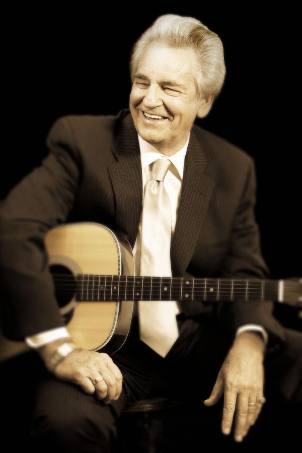 Portrait of man holding guitar.