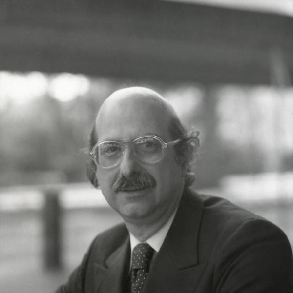 Portrait of bald man with glasses.