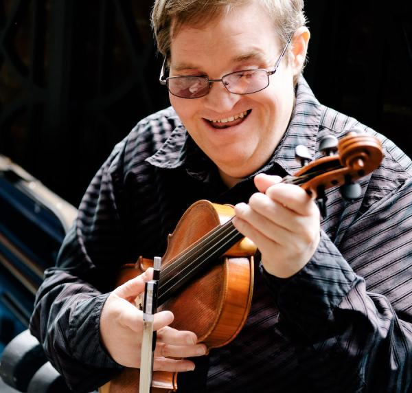 A man holding a fiddle