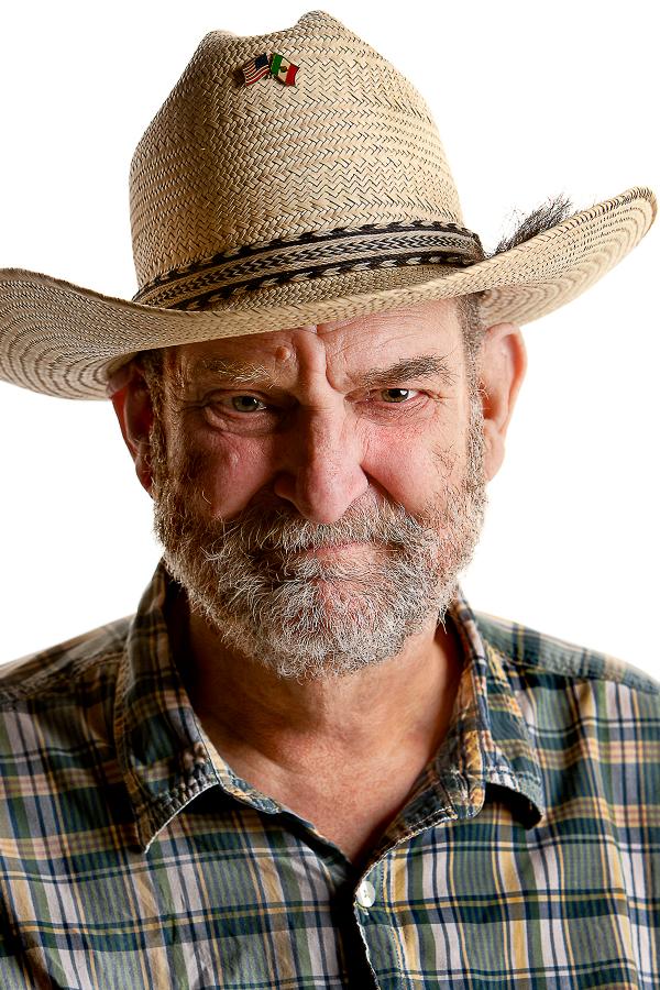 Portrait of man in straw hat.