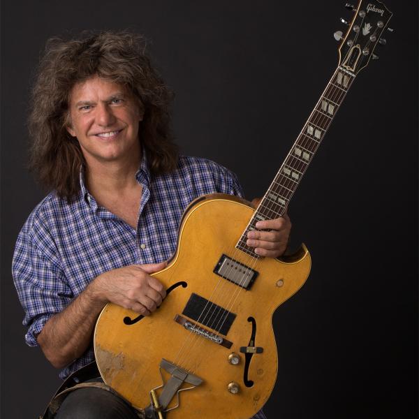 Portrait of man holding guitar. 