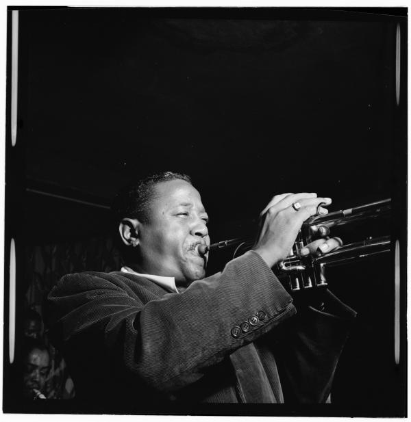Man playing trumpet on stage.