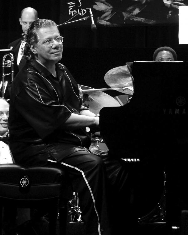 Man playing piano on stage.