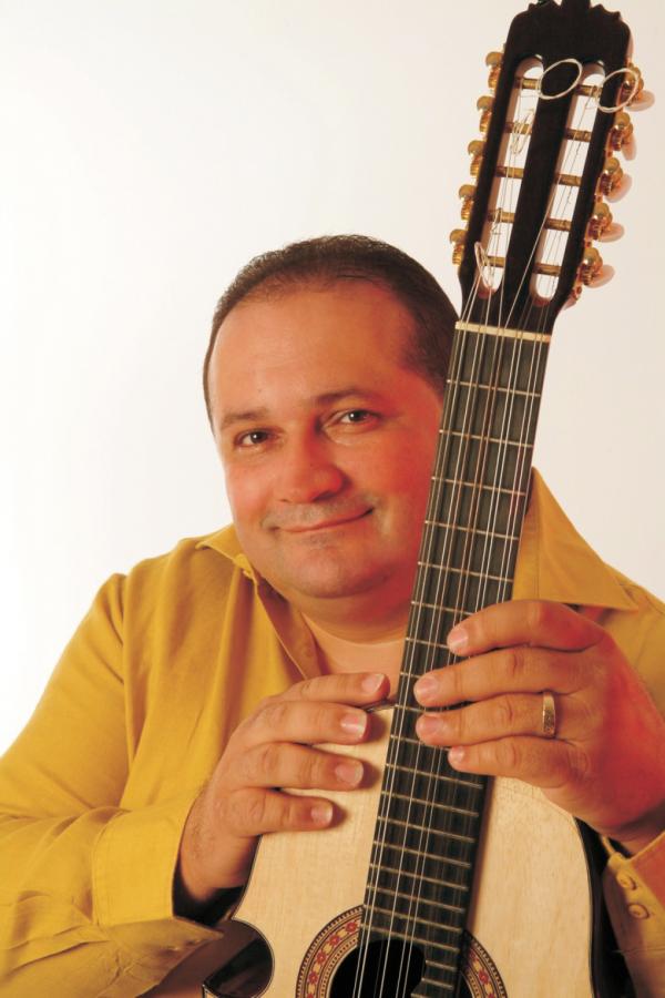 Man holding a cuatro.