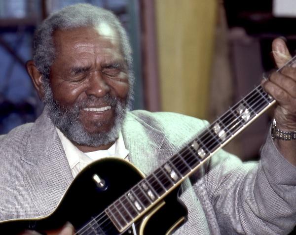 A man playing a guitar.