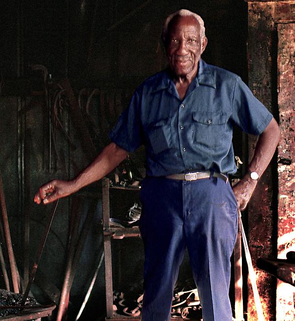 A man holing an iron rod.