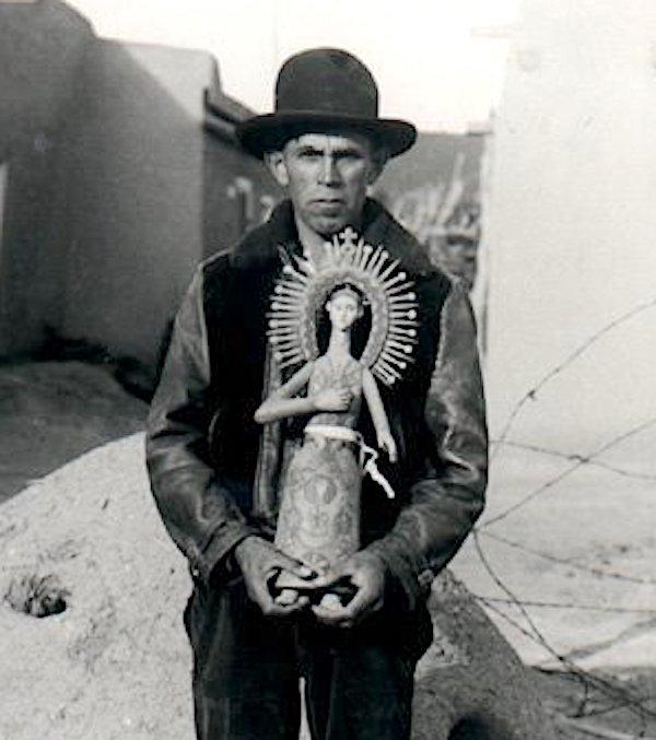 A man holding a ceramic scilpture. A man holding a ceramic sculpture.