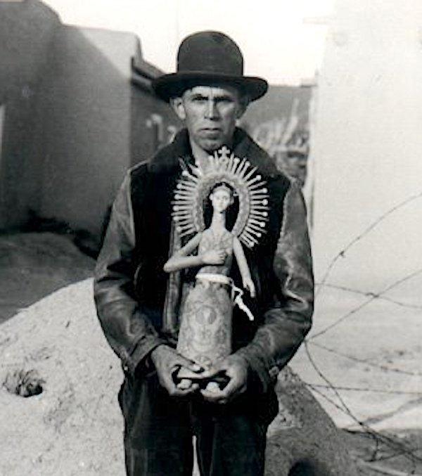 A man holding a ceramic sculpture.