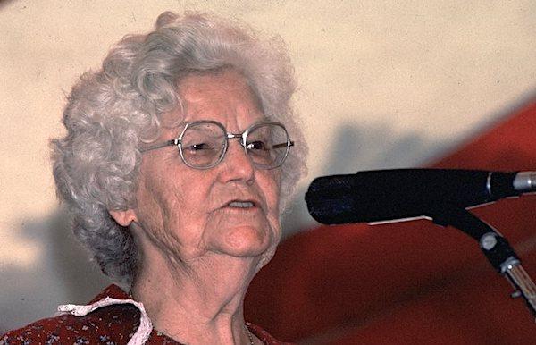 A woman singing into a microphone.