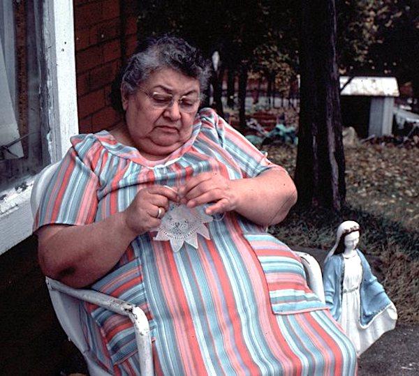 A woman woreks on a lace piece.
