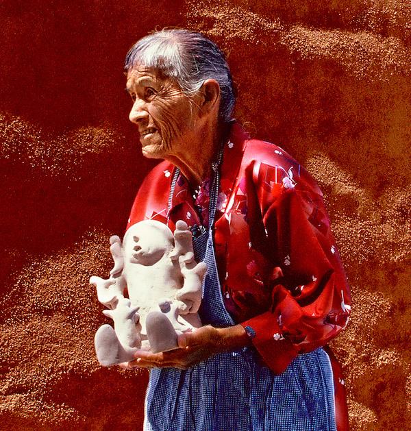 A wman holding a sculture ceramic vasse.