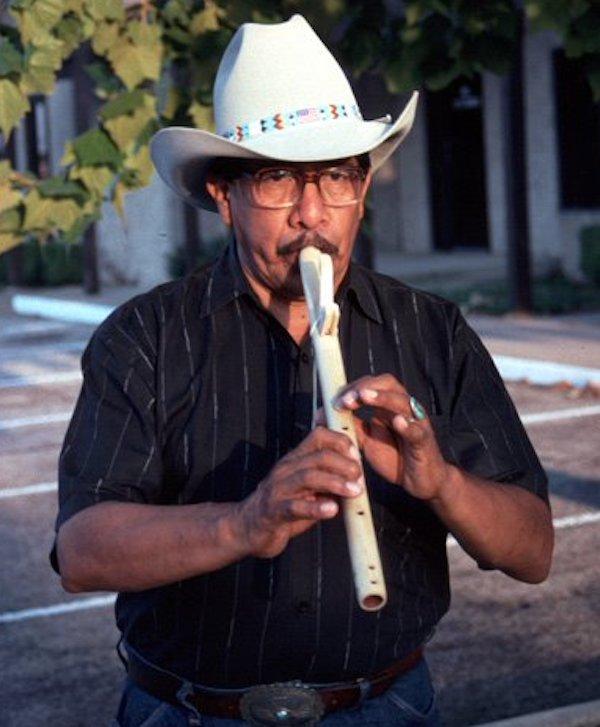 Man playing a flute.