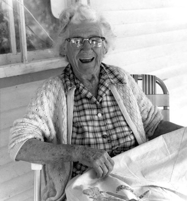 A woman showing an embroidery.