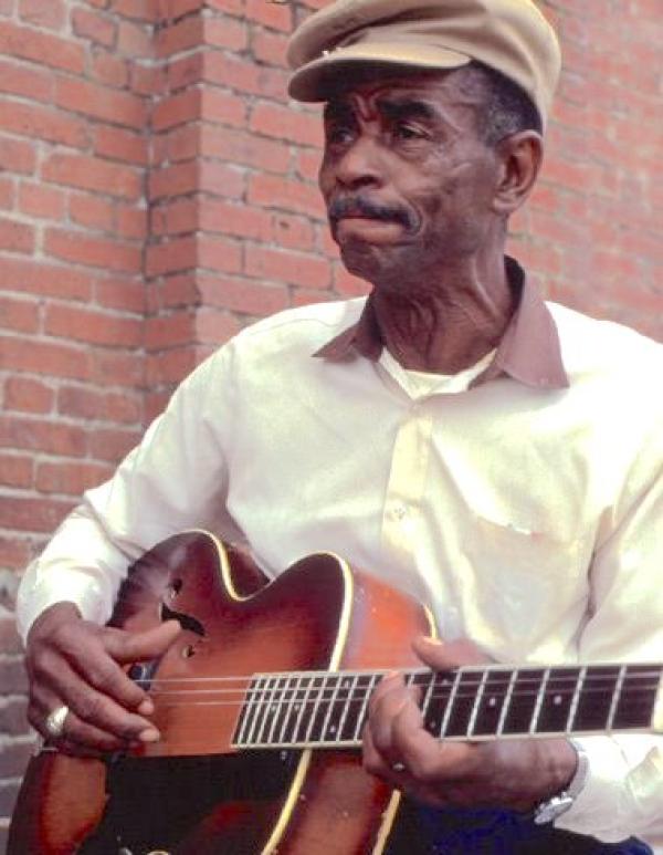 A man holding a guitar.