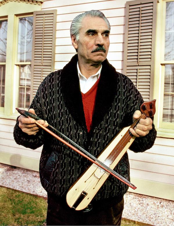 A man holding a string instrument.