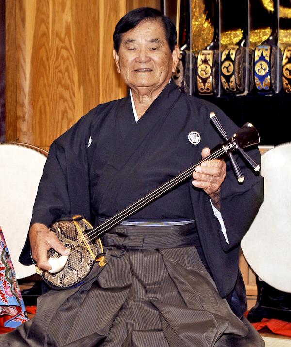 A man playing a string intrument.