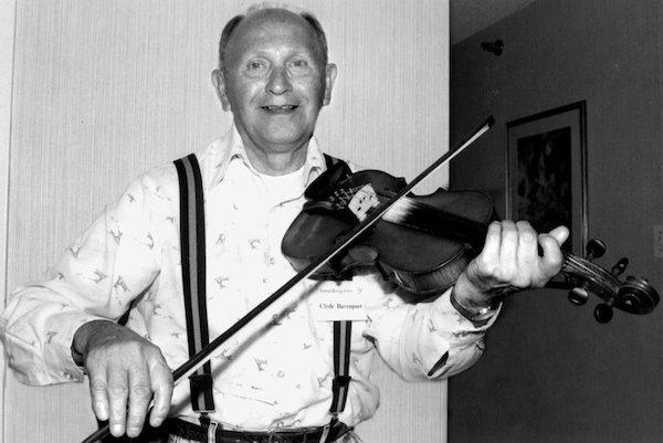 A man playing a fiddle. A man playing a fiddle.