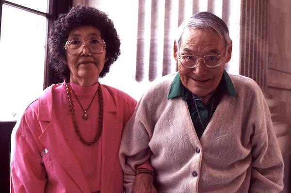 A man and a woman sittingh side by side.