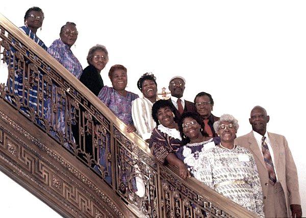 A gropu of people posing on a staircase.