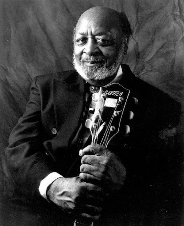 A man holding a guitar.