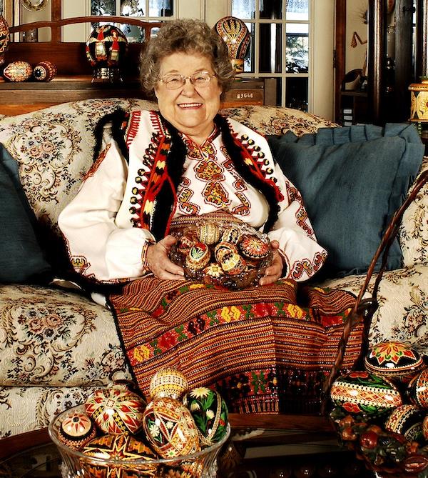 A woman sitting with her crafts.