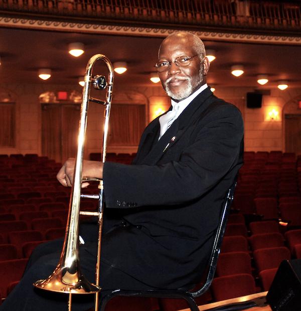 A man hiolding a trombone.