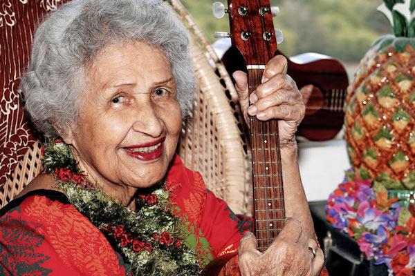 Woman holding a ukelele.