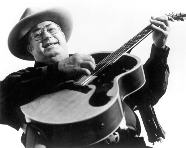 A man plying a guitar.