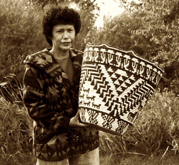 A woman holding a straw basket.