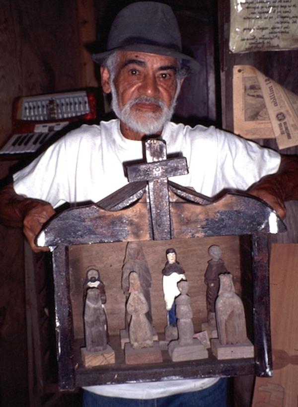 A man shows a wwoden craft.