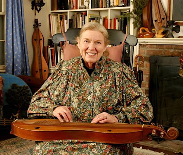A woman with a dulcimer on her lap.
