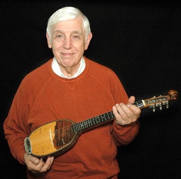 Man holding a mandolin.