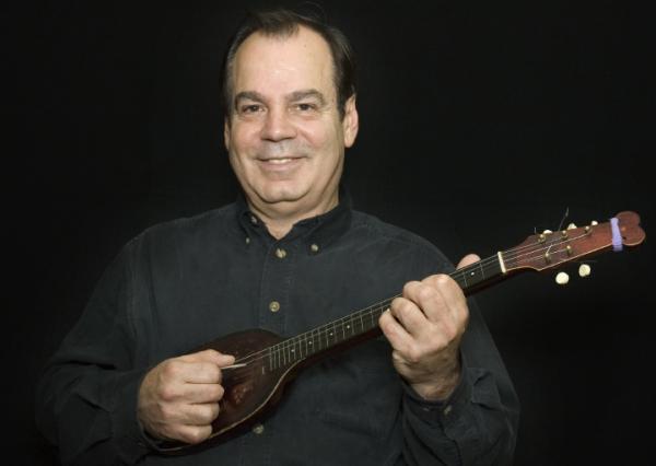 A man holding a mandolin.