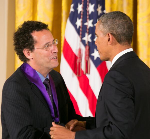 Kushner receiving his medal form President Obama.