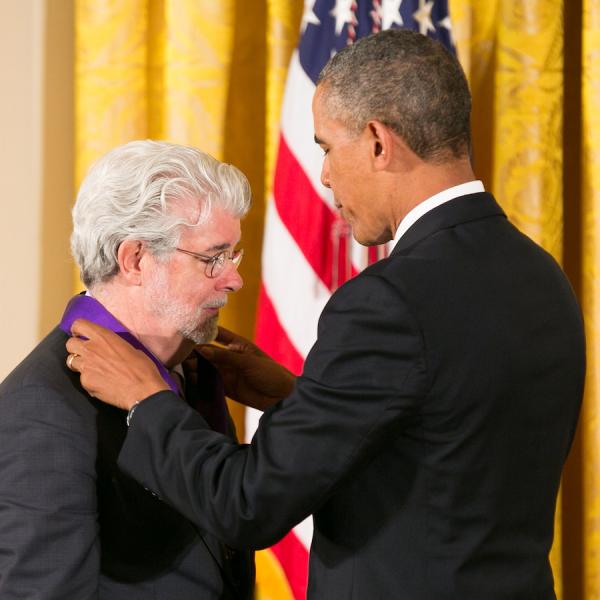 Lucas receiving his medal form President Obama.