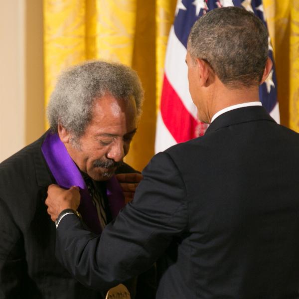 Toussaint receiving his medal form President Obama.