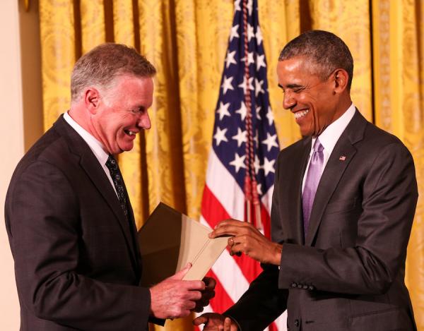Edward P. Henry receives a medal from President Obama.