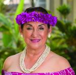 Portrait of woman wearing a purple floral wreath.